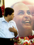 A mourner pays his respects as he walks past a portrait of business legend Dhirubhai Ambani at his residence in Mumbai. Photo: Reuters/Arko Datta