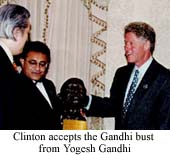 Clinton accepts the Gandhi bust from Yogesh Gandhi