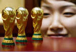 A jewellery store displays 24 carat gold miniatures of the FIFA World Cup trophy in Seoul 