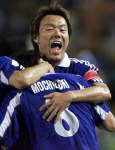 Ryuzo Morioka (back) celebrates with Shigeyoshi Mochizuki (8).