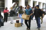 Enron employees leave the company's downtown headquarters with boxes of personal belongings on December 3, 2001 after the shattered company laid off about 4,000 employees. Reuters/Richard Carson