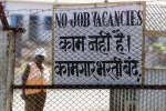 A security guard stands next to a gate at DPC