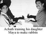 Achath training his daughter Maya to make rabbits
