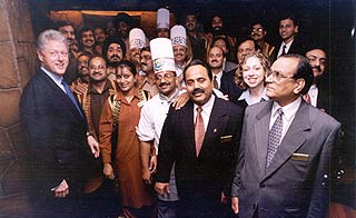 President Clinton and his daughter Chelsea with the staff at the Bukhara, Maurya Sheraton