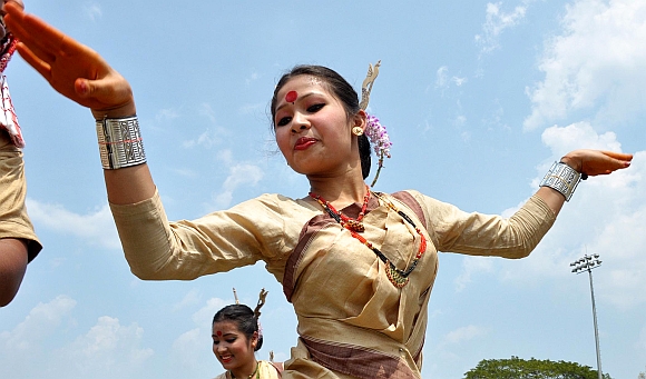 Youth in traditional Assamese attire perform Bihu