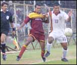 Karnataka's A S Firoze and Nengal's Momocha Singh battle for possession.